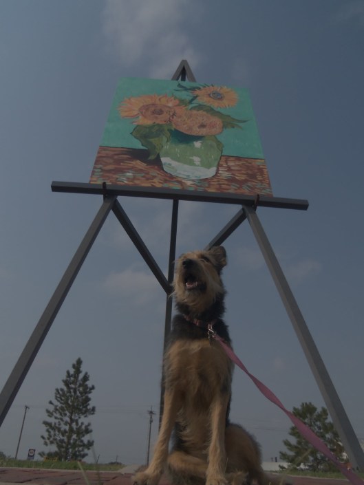 Lucy stands stall in front of an 80 foot tall Van Gogh replica.